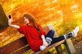 Girl taking self picture selfie with smartphone camera outdoors