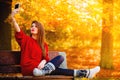 Girl taking self picture selfie with smartphone camera outdoors Royalty Free Stock Photo