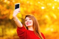 Girl taking self picture selfie with smartphone camera outdoors Royalty Free Stock Photo