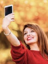 Girl taking self picture selfie with smartphone camera outdoors Royalty Free Stock Photo