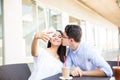 Girl Taking Selfie While Boyfriend Kissing On Cheek In Mall Royalty Free Stock Photo