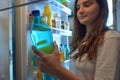 Girl taking Water from Refrigerator