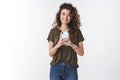 Girl taking your photo. Friendly-looking young cute girlfriend curly-haired holding smartphone capture vertical