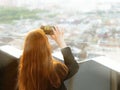 Girl taks a panorama photo of the ancient city with a smartphone. An observation deck at the town hall of the central Rinok square