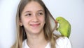 Girl Talk Parrot, Happy Kid Playing her Pet, Child Plays Bird at Home, Funny Indian Ring-Necked Parakeet Birds Cage Family