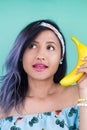 Girl talking with a banana. Yellow makeup. Fun Royalty Free Stock Photo