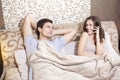 Girl talking on the cell phone while laying with his boyfriend Royalty Free Stock Photo