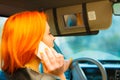 Girl talking on mobile phone while driving the car. Royalty Free Stock Photo