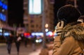 Girl talking on mobile phone at night in winter Royalty Free Stock Photo