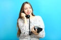 Girl is talking on an old wire phone Royalty Free Stock Photo