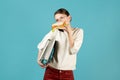 Girl talking on the phone, holding documents under the armpit and eats Royalty Free Stock Photo