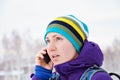 Girl talking on the phone outdoors in the winter. Royalty Free Stock Photo
