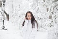 Girl talking on the phone outdoors in winter. Royalty Free Stock Photo