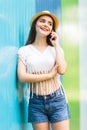 Girl talking phone on the street over color background Royalty Free Stock Photo