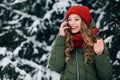Girl talking on smartphone in cold winter day Royalty Free Stock Photo
