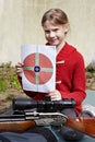 Girl with a target and a pneumatic gun