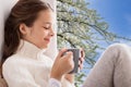 Girl with tea mug sitting at home window Royalty Free Stock Photo