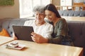 Girl teaching her grandmother how to use a tablet Royalty Free Stock Photo