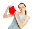 Girl tearing a heart-shaped pillow Royalty Free Stock Photo