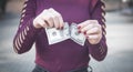 Girl tearing hundred dollar in hands