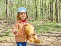 Girl with Teddy bear gives yellow flower.