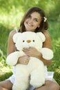 Girl with Teddy bear in the park Royalty Free Stock Photo
