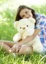 Girl with Teddy bear in the park Royalty Free Stock Photo