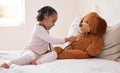 Girl, teddy bear and stethoscope in hospital game in medical, healthcare and wellness bedroom. Happy smile, curious Royalty Free Stock Photo