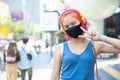 Girl teen cute punk hipster style red hair color wear face mask or face shield at outdoor public shopping walking street