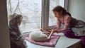 Girl teen and pets cat and dog a looking pet out the window, cat sleeps Royalty Free Stock Photo