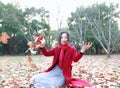 Girl teen playing with autumn leaves up in the air in autumn park Royalty Free Stock Photo