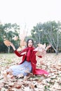 Girl teen playing with autumn leaves up in the air in autumn park Royalty Free Stock Photo