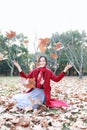 Girl teen playing with autumn leaves up in the air in autumn park Royalty Free Stock Photo