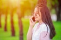 Girl teen on smartphone calling talking happy smile green outdor nature background Royalty Free Stock Photo