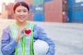 Girl teen worker in cargo container shipping port working with heart and good service mind concept