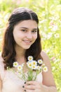 Girl teenager with bouquet of daisies on summer meadow Royalty Free Stock Photo