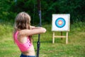 Girl teenager with bow nock and aims to target Royalty Free Stock Photo