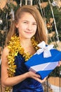 Girl teenager in elegant dress holds a Christmas present Royalty Free Stock Photo