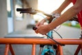 Girl teenager fastening bicycle lock on street parking