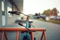 Girl teenager fastening bicycle lock on street parking