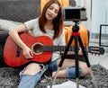 Girl teenager with guitar recording streaning with camera Royalty Free Stock Photo