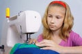 Girl learns to sew on an electric sewing machine Royalty Free Stock Photo