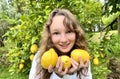 girl teenager have fun dancing smiles and laughs against the backdrop of a lemon tree in her hands she has lemons she