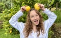 girl teenager have fun dancing smiles and laughs against the backdrop of a lemon tree in her hands she has lemons she