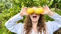 girl teenager have fun dancing smiles and laughs against the backdrop of a lemon tree in her hands she has lemons she