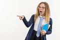 Girl teenager, high school student, on white background, in school uniform and pointing her index finger away Royalty Free Stock Photo