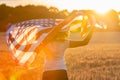 Girl Teenager Holding USA Flag in Field at Sunset Royalty Free Stock Photo