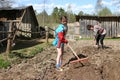 Girl teenager loose soil using a hand garden tools, Russia.