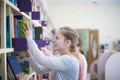 Girl of 13 years old choosing book in library