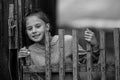 Girl teenager near the wooden village fence.